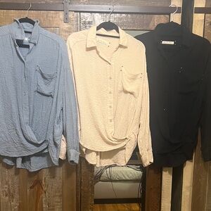 Free People Set of Three Button-Up Shirts in Blue, Cream, and Black